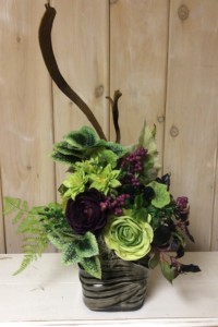 $75. WK-403.   Brown wrap ceramic pot with burgundy and green Ranunculus