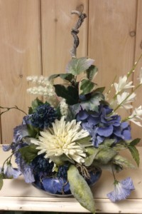 $45.  WK-333. Low “tie dye” blue ceramic pot with blue and white flowers