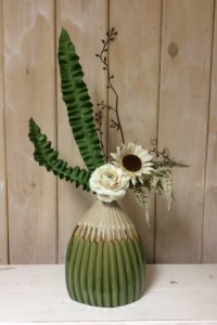 $55  WK 8     Cream and green ridged ceramic vase with cream Ranunculus and ruffled fern leaves