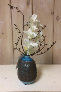 $37. WK-439A.  Turquoise and brown ceramic bud vase with white Orchid